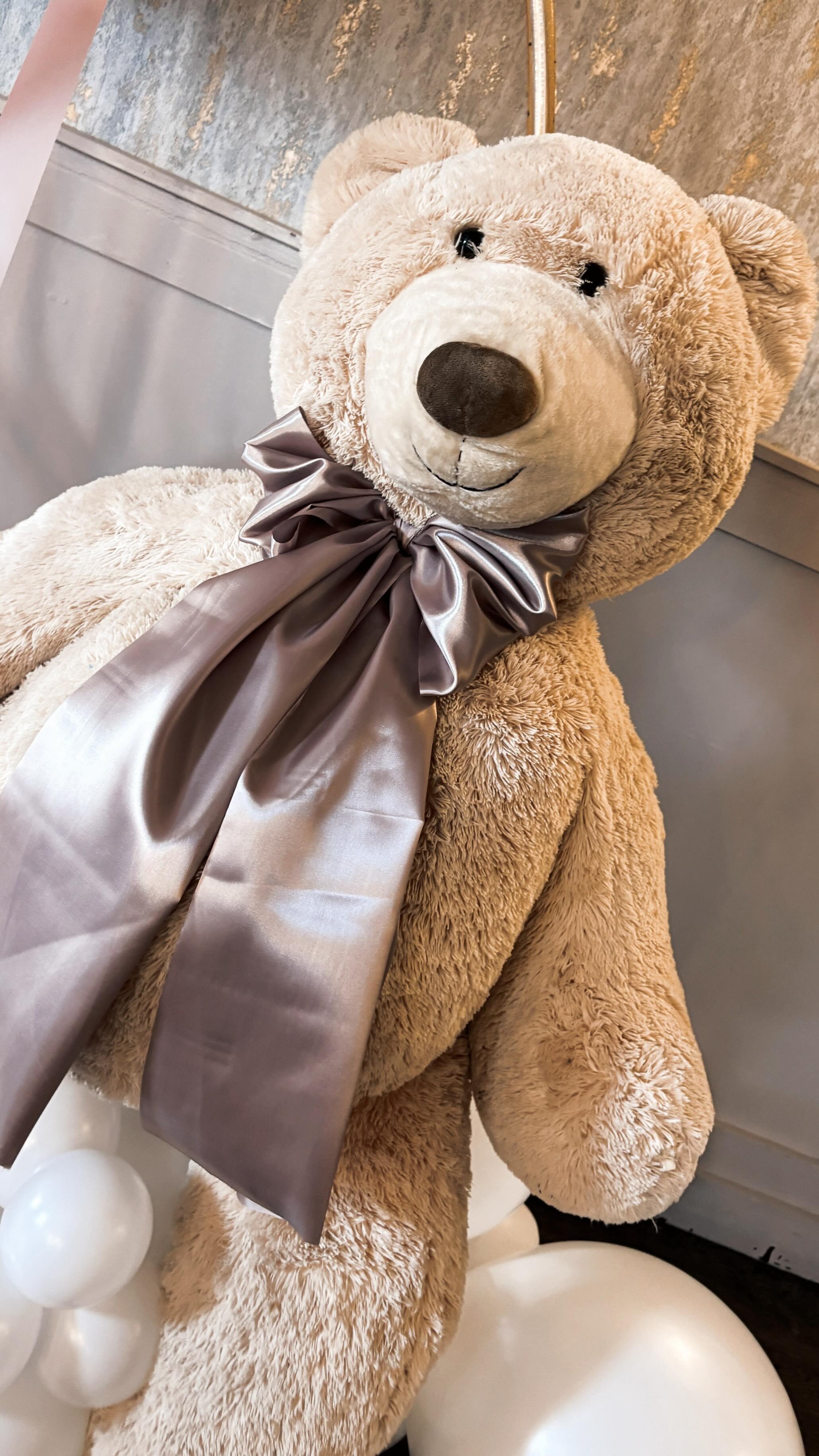Giant teddy bear with satin bow for Christening